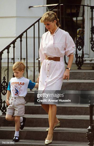 Prince Harry wears a Thomas the Tank Engine tee-shirt when he leaves nursery school with his mother, Diana, Princess of Wales in June 1989 in London,...