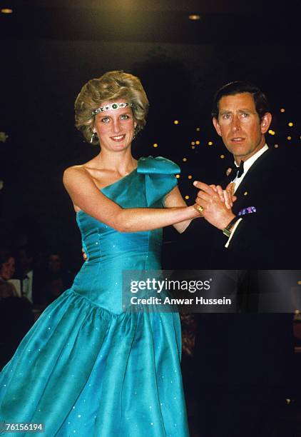 Prince Charles, Prince of Wales and Diana, Princess of Wales, wearing a green satin evening dress designed by David and Elizabeth Emanuel and an...