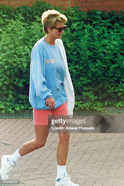 Diana, Princess of Wales, wearing a pale blue sweatshirt, pink cycling shorts and sunglasses, leaves Chelsea Harbour Club on August 24, 1994 in...