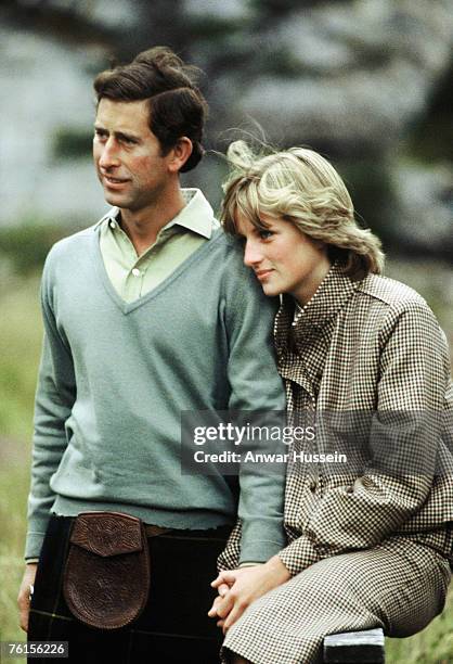 Prince Charles, Prince of Wales and Diana, Princess of Wales, wearing a suit designed by Bill Pashley, pose for a photo on the banks of the river Dee...