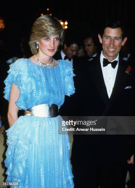 Prince Charles, Prince of Wales and Diana, Princess of Wales, wearing a pale blue dress with a silver waist belt designed by Bruce Oldfield, attend a...
