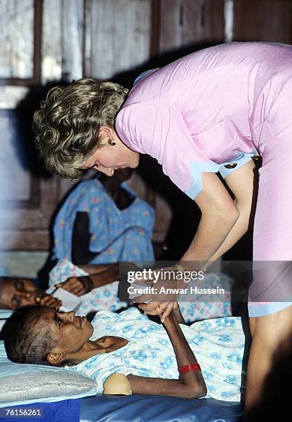 Diana, Princess of Wales comforts a dying woman at Mother Teresa's Hospice in Calcutta in February 1992.