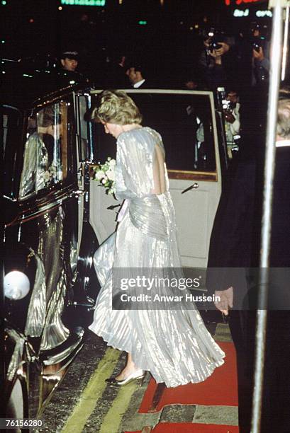 Diana, Princess of Wales, wearing a silver lame dress with an open back designed by Bruce Oldfield, attends the Film Premiere of the James Bond film...