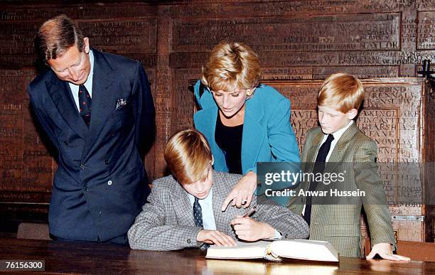 Prince William signs in on his first day at Eton College watched by his parents, he Prince and Princess of Wales and brother, Prince Harry on...