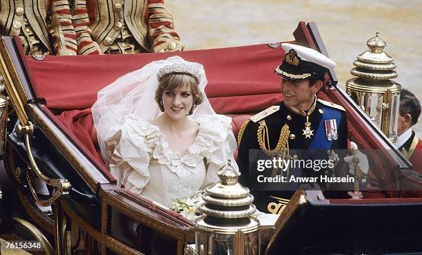 Prince Charles, Prince of Wales and Diana, Princess of Wales, wearing a wedding dress designed by David and Elizabeth Emanuel and the Spencer family...