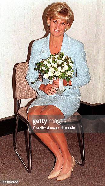 Diana, Princess of Wales is presented with the first rose to be named after her at the British Lung Foundation offices on April 21, 1997 in London,...