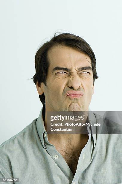 "man making sour face, portrait" - disgusto foto e immagini stock