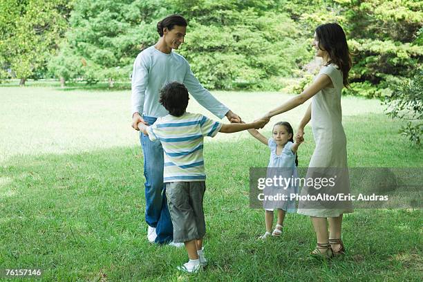 family outdoors playing ring-around-the-rosy - ring around the rosy stock pictures, royalty-free photos & images