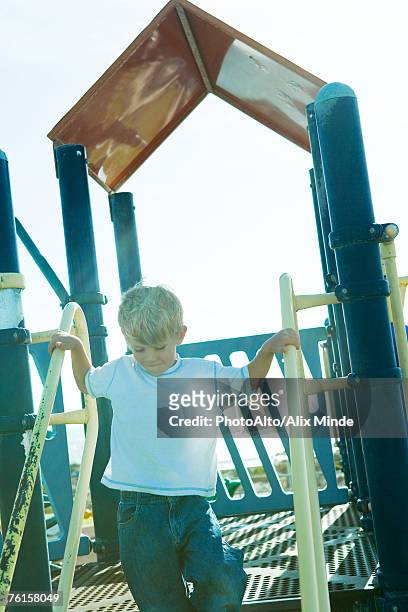 "boy on playground equipment, holding onto railing" - northern european descent ストックフォトと画像