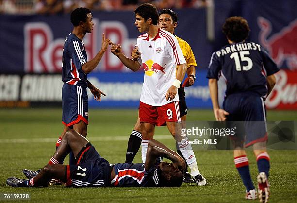 Juan Pablo Angel of the New York Red Bulls is confronted by James Riley of the New England Revolution after getting red carded on a collision with...