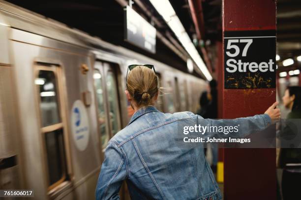 man standing on subway station - no pants subway stock pictures, royalty-free photos & images