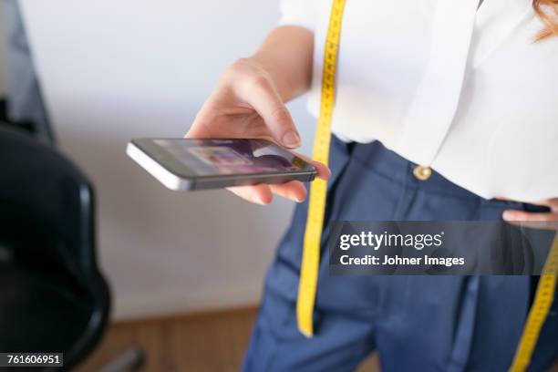 woman using cell phone - tailor pants stock pictures, royalty-free photos & images