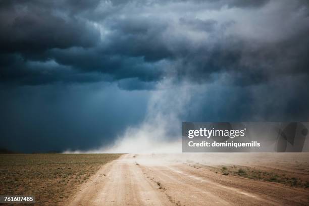 dust storm on a dirt road, ulgii, mongolia - dust storm stock pictures, royalty-free photos & images