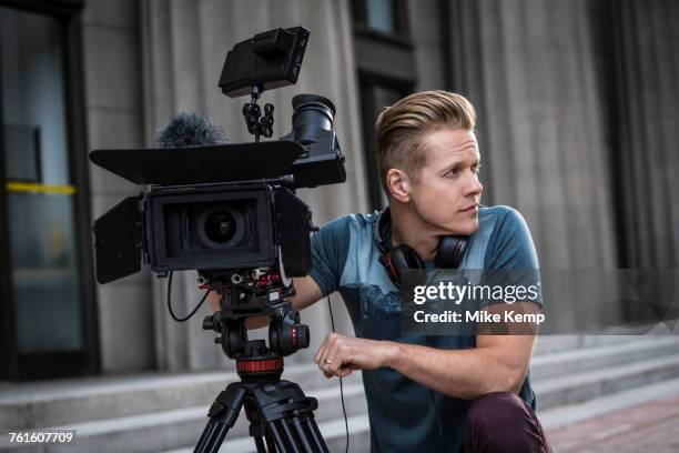 portrait of camera operator looking away - regista cinematografico foto e immagini stock
