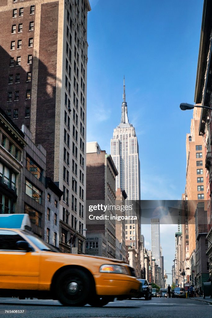 Low angle view of a yellow cab on 5th Avenue, Manhattan, New York, America, USA