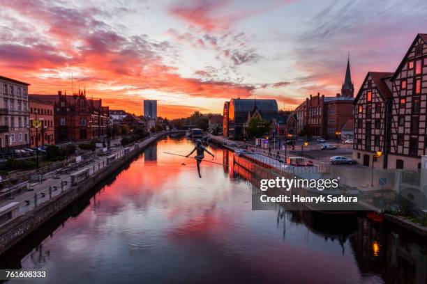 poland, kuyavian-pomeranian, bydgoszcz, brda river, dramatic sky reflecting in water surface - bydgoszcz stockfoto's en -beelden