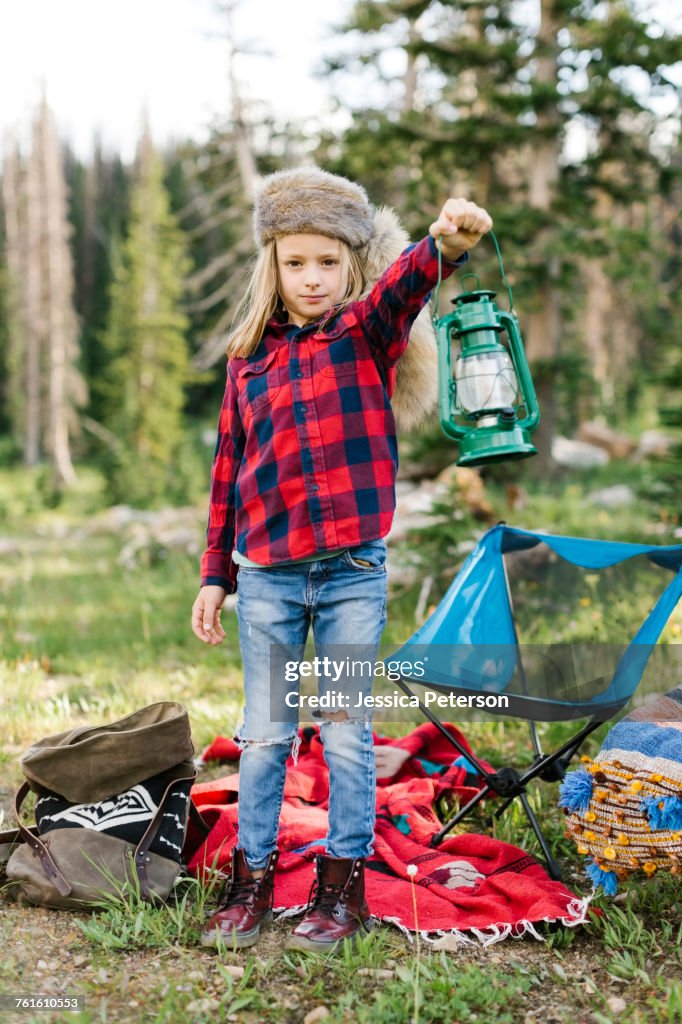 Portrait of boy (6-7) with camping gear in forest