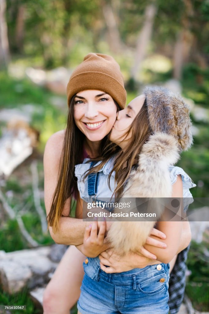 Portrait of mother with daughter (8-9) hiking in forest