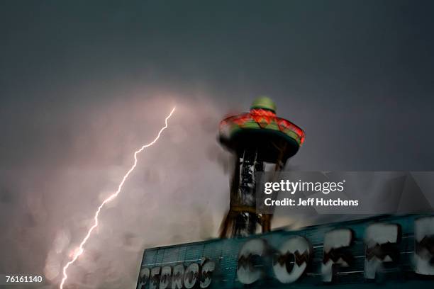 Lightning strikes near the giant sombrero lookout tower during a summer afternoon thunderstorm at South of the Border on July 21, 2006 in Dillon,...