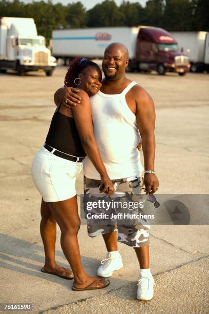 Truck drivers Johnny and Bridget Carpenter hang out at the truck stop during a rest stop at South of the Border on July 21, 2006 in Dillon, South...