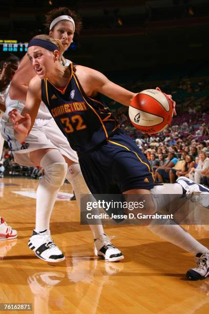 Katie Douglas of the Connecticut Sun drives against Janel McCarville of the New York Liberty at Madison Square Garden August 17, 2007 in New York...