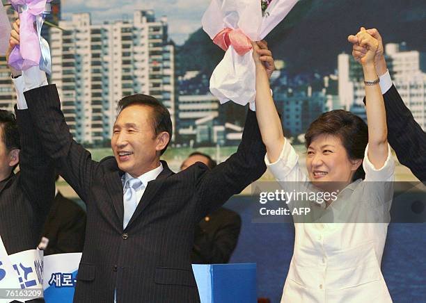 Lee Myung-Bak , a former construction tycoon and former Seoul mayor, waves hands with Park Geun-Hye , former chairwoman of the main opposition Grand...