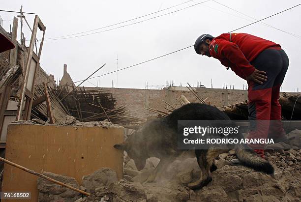 Spanish rescuer and his sniffer dog search for bodies among the rubble in Pisco, 240 km south of Lima, on August 18th, 2007. The Richter Scale...