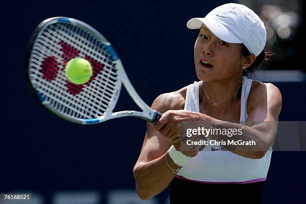 Zi Yan of China returns a shot against Justine Henin of Belgium during the Rogers Cup at the Rexall Center August 18, 2007 in Toronto, Ontario,...