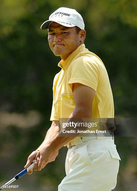 Shigeki Maruyama of Japan watches his missed putt on the 16th green during the third round of the Wyndham Championship at Forest Oaks Country Club on...