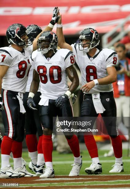 Quarterback Matt Schaub of the Houston Texans celebrates with receivers Andre Johnson and Mark Bruener after running five yards for a touchdown...