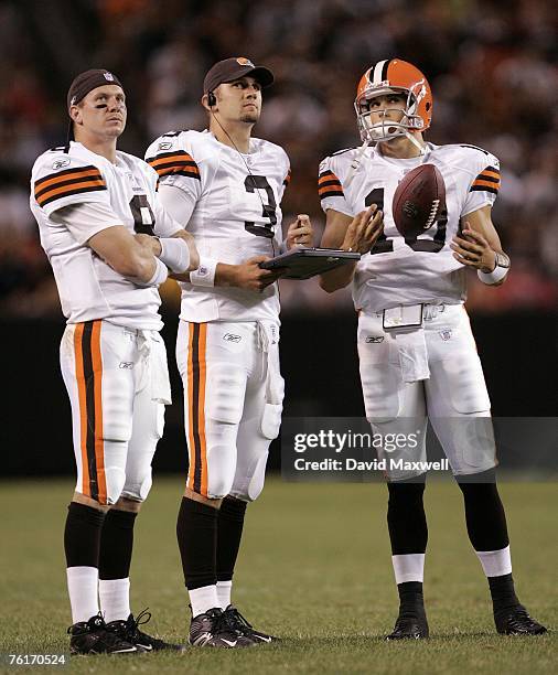 Cleveland Browns quarterbacks Charlie Frye, Derek Anderson, and Brady Quinn look at the scoreboard during the fourth quarter of a pre-season game...