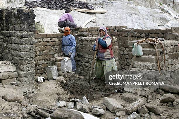 Lifestyle-India-Kashmir-architecture-tourism-culture,FEATURE" by Tripti Lahiri In this picture taken 21 July 2007, Ladakhi workers rebuild a house...