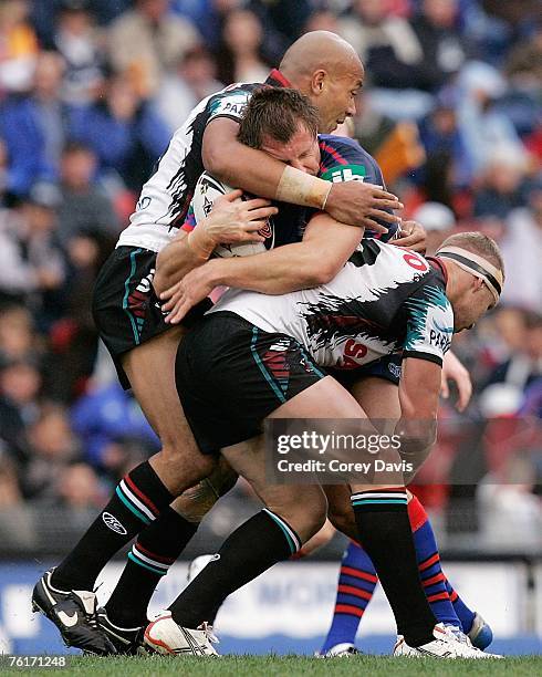Reegan Tanner of the Knights is tackled during the round 23 NRL match between the Newcastle Knights and the Penrith Panthers at EnergyAustralia...