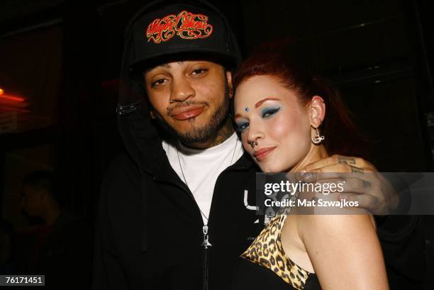 Singer Travis McCoy and Penthouse Pet Justine Joli arrive at McCoy's birthday party at Angels and Kings on August 18, 2007 in New York City.