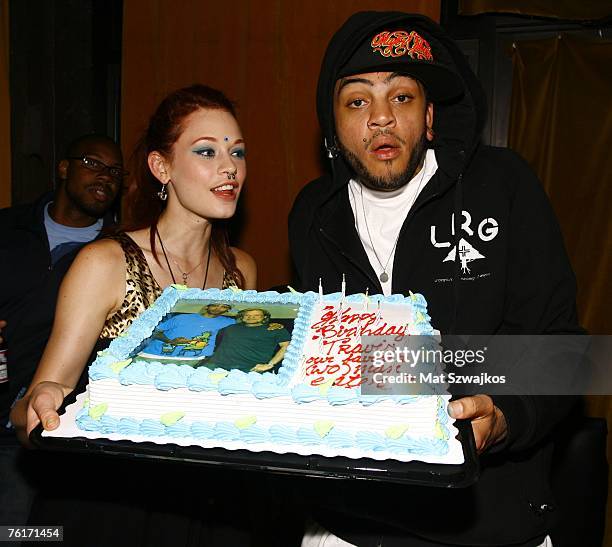 Penthouse Pet Justine Joli presents singer Travis McCoy his birthday cake at his birthday party at Angels and Kings on August 18, 2007 in New York...