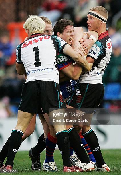 Kurt Gidley of the Knights is wrapped up during the round 23 NRL match between the Newcastle Knights and the Penrith Panthers at EnergyAustralia...