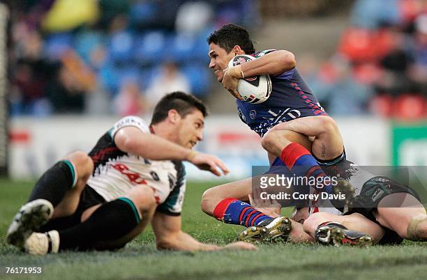 Brad Tighe of the Knights is tackled during the round 23 NRL match between the Newcastle Knights and the Penrith Panthers at EnergyAustralia Stadium...