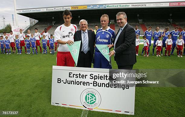 President Theo Zwanziger of the German Football Association and Peter Freymuth pose with team captains Thomas Denker of Essen and Jan-Niklas Temme of...