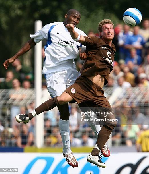 Darlington Omodiagbe of Jena and Marvin Braun of St. Pauli jump for a header during the Second Bundesliga match between Carl Zeiss Jena and FC St....
