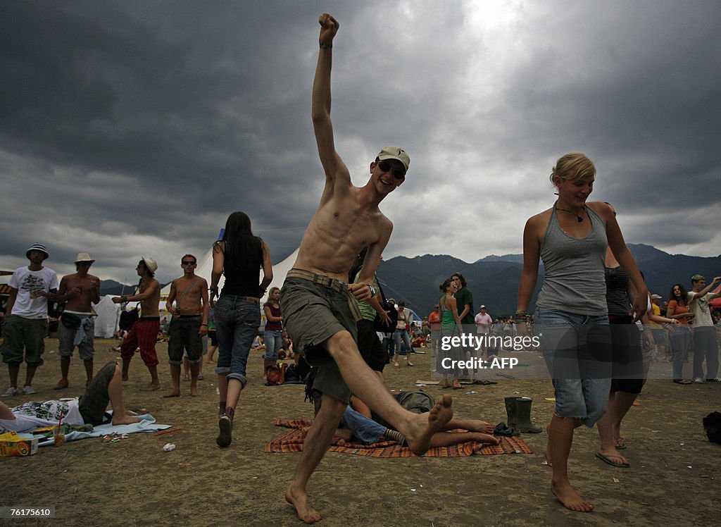 Festival goers dance in the rain, 19 Aug