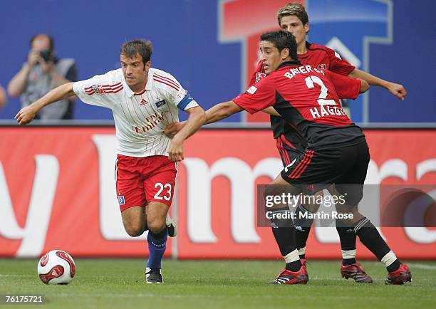 Karim Haggui of Leverkusen tries to stop Rafael van der Vaart of Hamburg during the Bundesliga match between Hamburger SV and Bayer Leverkusen at the...