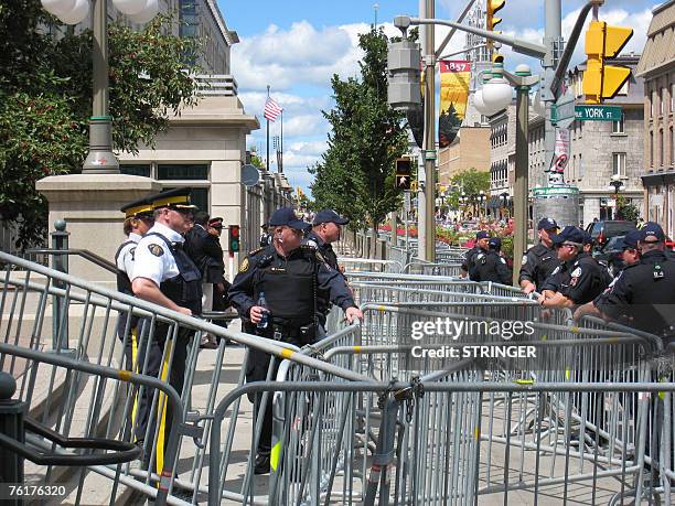 Police wrap the US embassy and Parliament Hill 19 August 2007 in Ottawa as protestors gather to decry an upcoming meeting of Canada's Prime Minister...