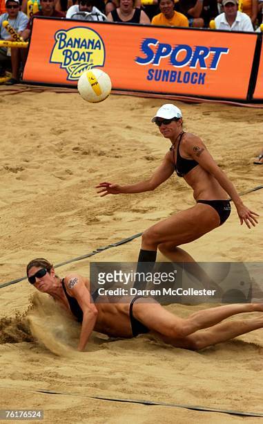 Nicole Branagh dives for a ball while teammate Elaine Youngs looks on August 19, 2007 at the AVP Bob's Store Boston Open at Marina Bay in Quincy,...