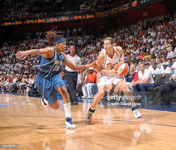Evanthia Maltsi of the Connecticut Sun drives against Monique Currie of the Washington Mystics on August 19, 2007 at Mohegan Sun Arena in Uncasville...