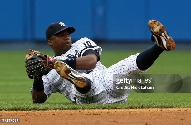 Wilson Betemit of the New York Yankees throws from the ground after falling down against the Detroit Tigers on August 19, 2007 at Yankee Stadium in...