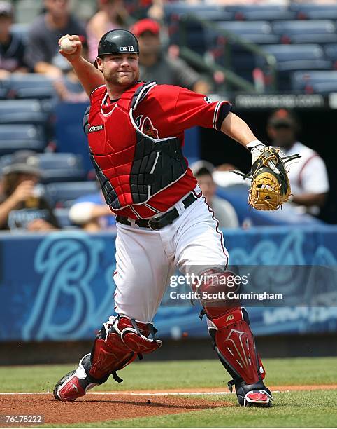 Brian McCann of the Atlanta Braves fields a bunt by Stephen Drew of the Arizona Diamondbacks at Turner Field August 19, 2007 in Atlanta, Georgia. The...