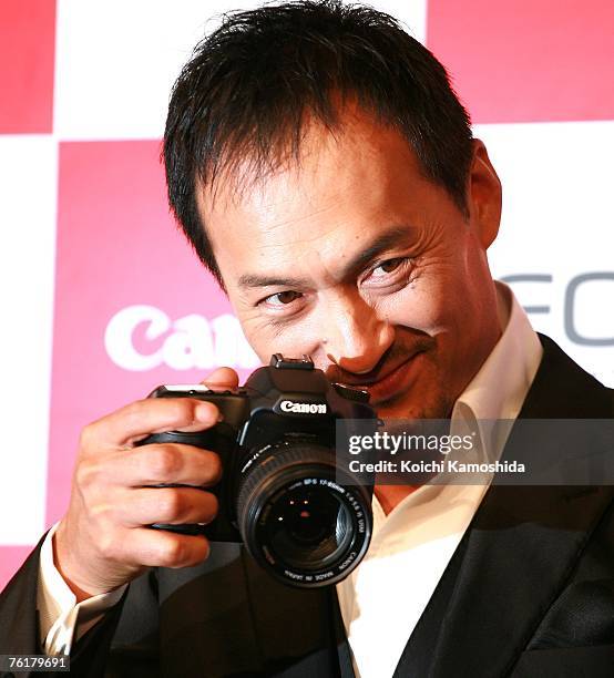 Japanese actor Ken Watanabe displays the new Canon EOS 40D digital SLR camera during a press preview on August 20, 2007 in Tokyo, Japan. The new...
