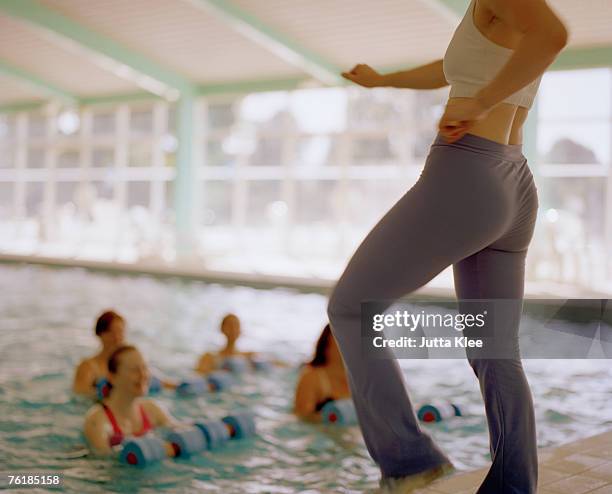 women doing a water aerobics class - swimming classroom stock-fotos und bilder