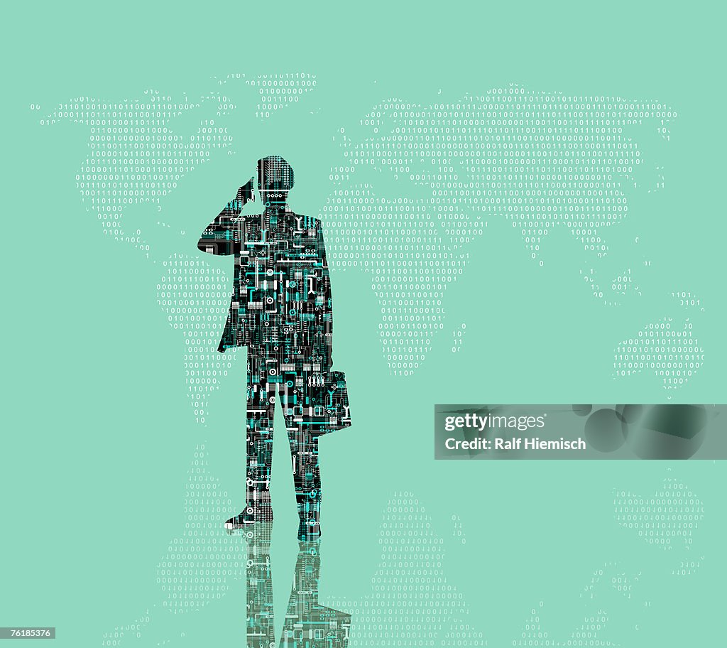 A businessman with a mobile phone and a briefcase standing in front of a world map