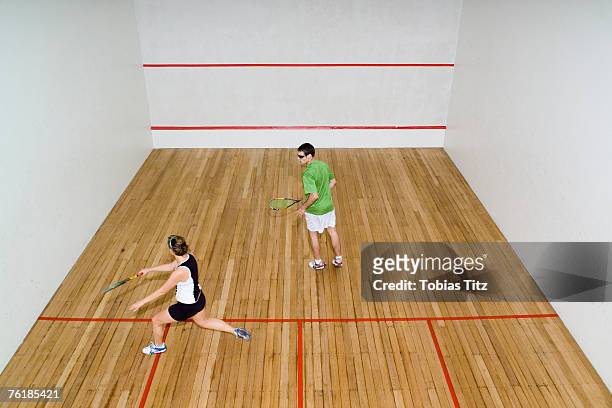 high angle view of two people playing squash - squash racquet stockfoto's en -beelden